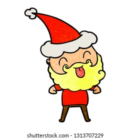 man with beard sticking out tongue wearing santa hat
