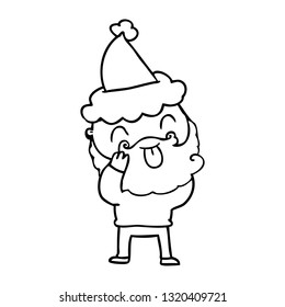 man with beard sticking out tongue wearing santa hat