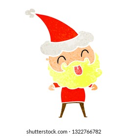 man with beard sticking out tongue wearing santa hat
