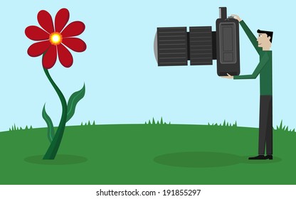 Man with a big camera, photographing a flower