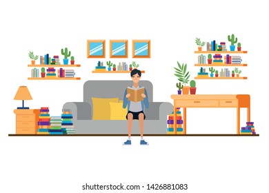 man with book in hands in living room
