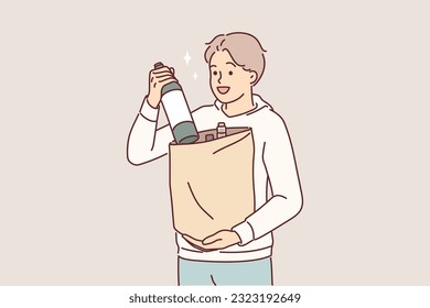 Man with bottle of wine in paper bag returns from grocery store and offers to drink bordeaux. Positive young guy bought wine rejoices at opportunity to try delicious alcoholic drink