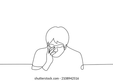 man bowed head and grabbed face with hand - one line drawing vector. concept of headache, disappointment or cringe