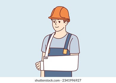 Man builder with broken arm after accident at workplace and looks at screen. Guy builder or foreman in hardhat and work overalls got injured during construction for employees insurance concept