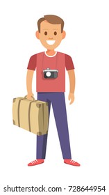 Man with camera that hangs on neck and vintage suitcase