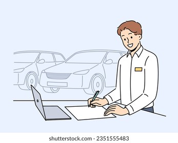 Man car salesman stands in showroom near vehicles and fills out contract for sale of sedan. Successful guy works as sales agent in car dealership, helping people get automobiles at bargain price.