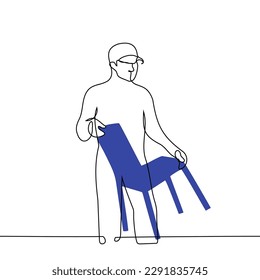 man carries a chair - one line drawing vector. concept loader loads furniture, moving, packing, rearranging and transporting furniture