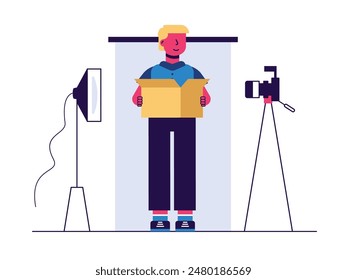 Man carrying box, preparing for photoshoot studio with camera, background and lighting. Character design. Vector flat illustration
