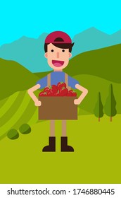 a man carrying a box of tomatoes with mountain view