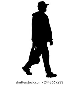 A man carrying a grocery bag in silhouette