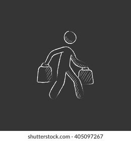 Man carrying shopping bags. Drawn in chalk icon.