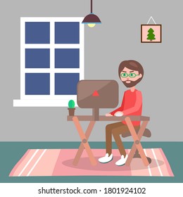 Man in casual clothes sitting at home on chair and browsing or working on computer in evening. Male bearded character works at home, freelancer at the desk. Remote worker or student in the room