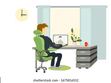 a man in a chair at the table is negotiating a video call. time for remote work