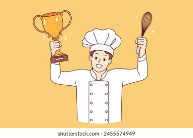 Man chef cook celebrates victory in professional culinary tournament, holds golden cup and whisk in hands. Restaurant chef in white uniform and hat won speed-cooking delicacy competition