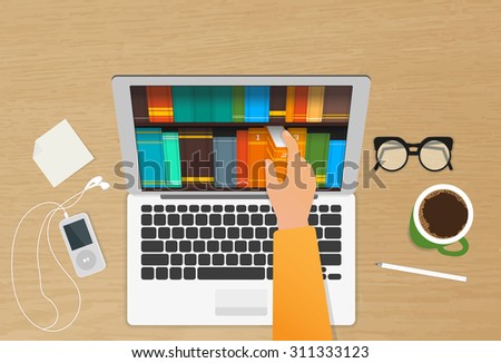 Man chooses eBooks in the Internet store from his laptop placed on the realistic wooden table