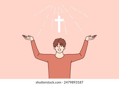 Man with christian cross above head rejoices at light coming from heaven and calls to visit church for prayers. Christian guy believes in miracle obtained by attending religious masses.