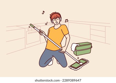 Man cleaning floor with mop stands in pose of rock musician imagining that is holding guitar and performing at concert. Guy in headphones does cleaning dreaming of performing at music rock festival 