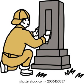 A man cleaning a grave