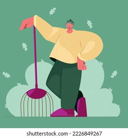 man cleans leaves in autumn in warm colors of paint