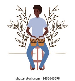 man with congas and branches and leaves in the background