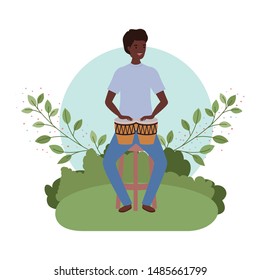 man with congas and branches and leaves in the background