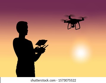 A man controls a drone, black silhouette on a sunset background. Modern flat vector graphics.