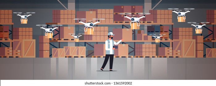 man courier hold wireless remote control parcel drones air delivery modern logistic system fast shipping concept cargo copter mail service warehouse interior horizontal