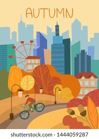 Man cycling through a city park in autumn with colorful orange foliage on the trees conceptual of the seasons against a backdrop of skyscrapers