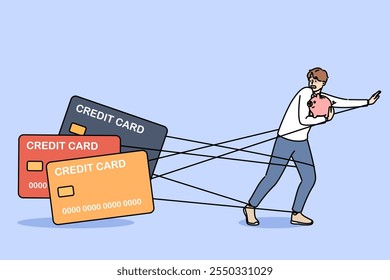 Man debtor has become hostage to loans and is running away from bank cards holding piggy bank in hands. Problems of credit dependence are caused by lack of freedom of guy who owes money