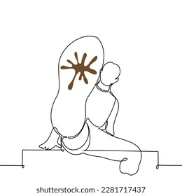man demonstrates to the viewer a close up muddy sole - one line drawing vector. concept get into shit