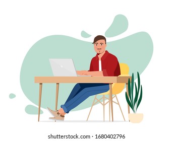 The man at the desk with a laptop. Freelancer or office worker.