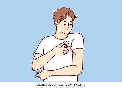 Man with diabetes makes injection in arm to lower blood sugar and avoid insulin shock. Guy is experiencing problems and need for regular injections after suffering from diabetes or infectious flu