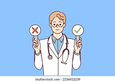 Man doctor with stethosop around neck demonstrates signs with check mark and cross. Young guy therapist in white coat shows signs of presence or absence of disease in patient. Flat vector design 