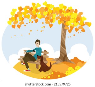 man with dog sitting on bench and using telephone under autumn tree