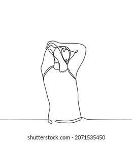 man doing exercises to warm up the muscles of the arms - one line drawing vector. concept of stretching, charging, training, exercise for sore hands or against diseases of the neck and spine