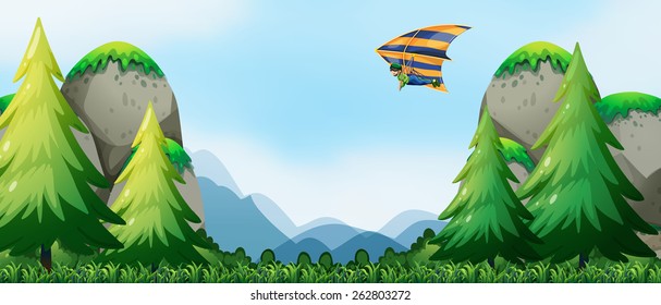 Hombre haciendo ala delta sobre las montañas
