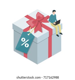 Man doing shopping online using a laptop and purchasing a big gift on sale, e-commerce and celebration concept