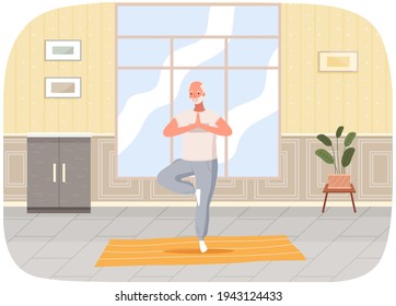 Man doing yoga at home. Elderly happy man standing in tree pose. Person takes care of his health