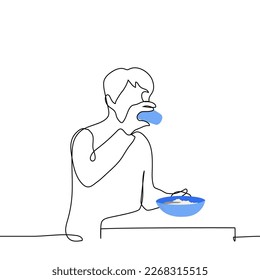 hombre bebiendo mientras está sentado en una mesa con un tazón de avena - un vector de dibujo de una línea. desayuno concepto, avena matutina