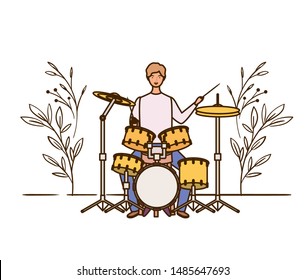 man with drum kit and branches and leaves in the background