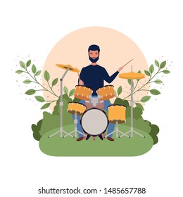 man with drum kit and branches and leaves in the background
