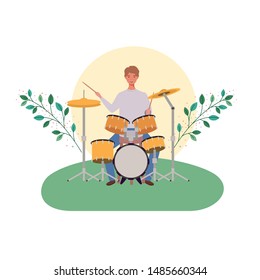 man with drum kit and branches and leaves in the background