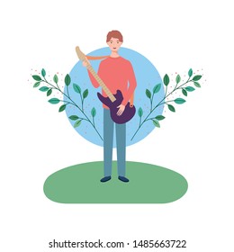 man with electric guitar and branches and leaves in the background