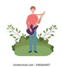 man with electric guitar and branches and leaves in the background