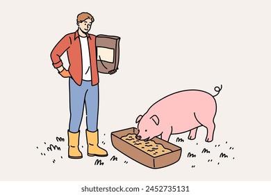 Man farmer engaged in livestock farming and pours feed from grains and cereals for pigs. Guy passionate about livestock farming monitors nutrition of animals, for accelerate growth of piglet