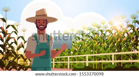 man farmer with tablet monitoring corn field condition countryman controlling agricultural products organization of harvesting smart farming concept landscape background flat horizontal portrait