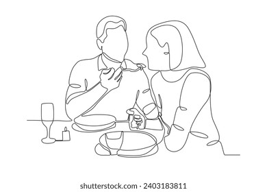 A man feeds his girlfriend. Candle light dinner one-line drawing