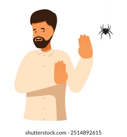 Hombre que se siente disgustado levantando las manos en la araña que cuelga en el Web, concepto de la aracnofobia