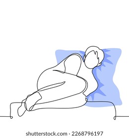 man in a fetal position lies on a short sofa with a pillow under his head - one line drawing vector. concept comfort alone