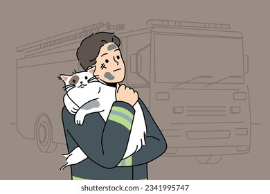 Man firefighter with cat heroically rescued from burning house stands near fire truck and hugs pet. Brave guy in uniform of firefighter or rescue worker helped cat get out of trouble